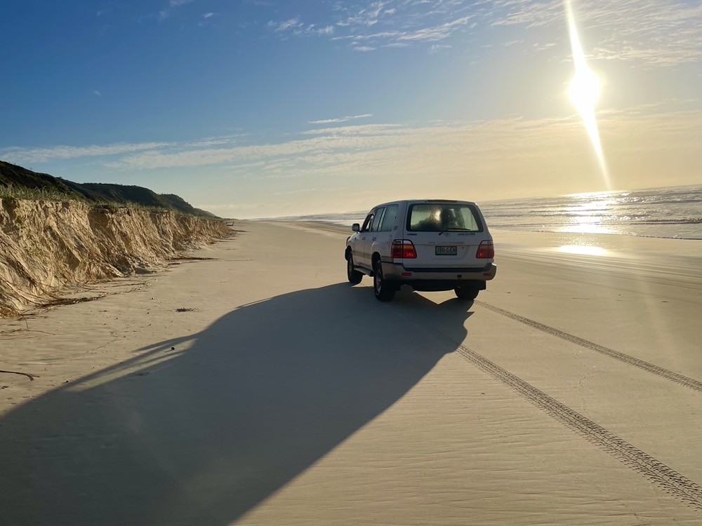 Land Cruiser on a beach at sunset